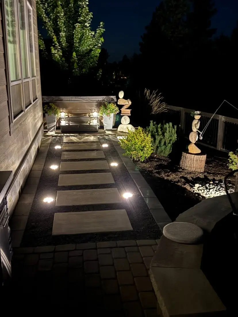 Stepping-stone path with in-ground lights at night