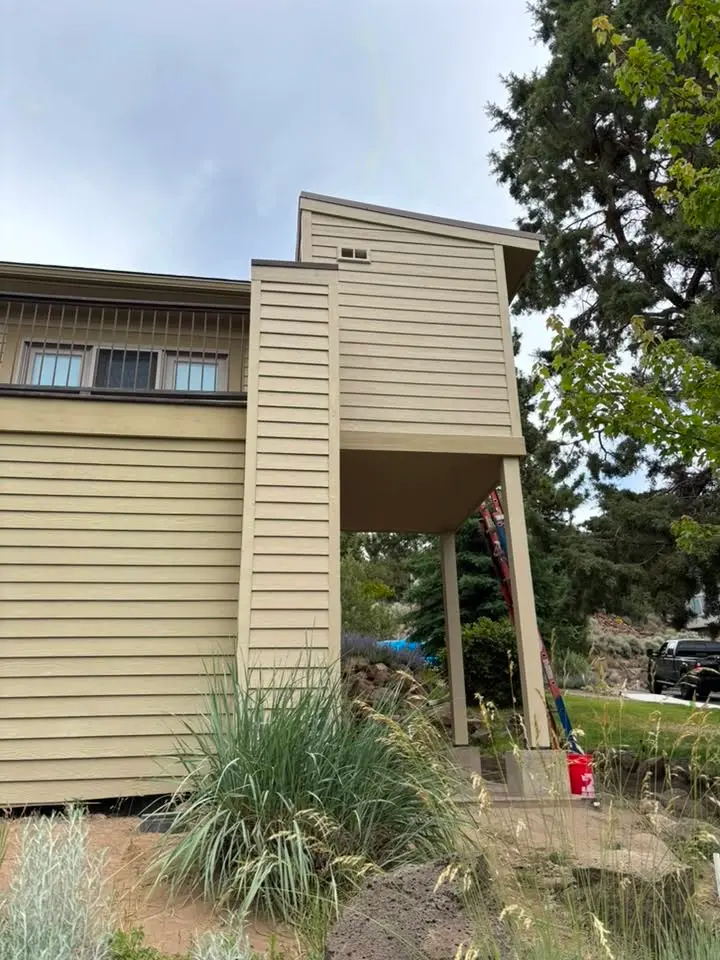 New lap siding on a two-story home with a covered entry